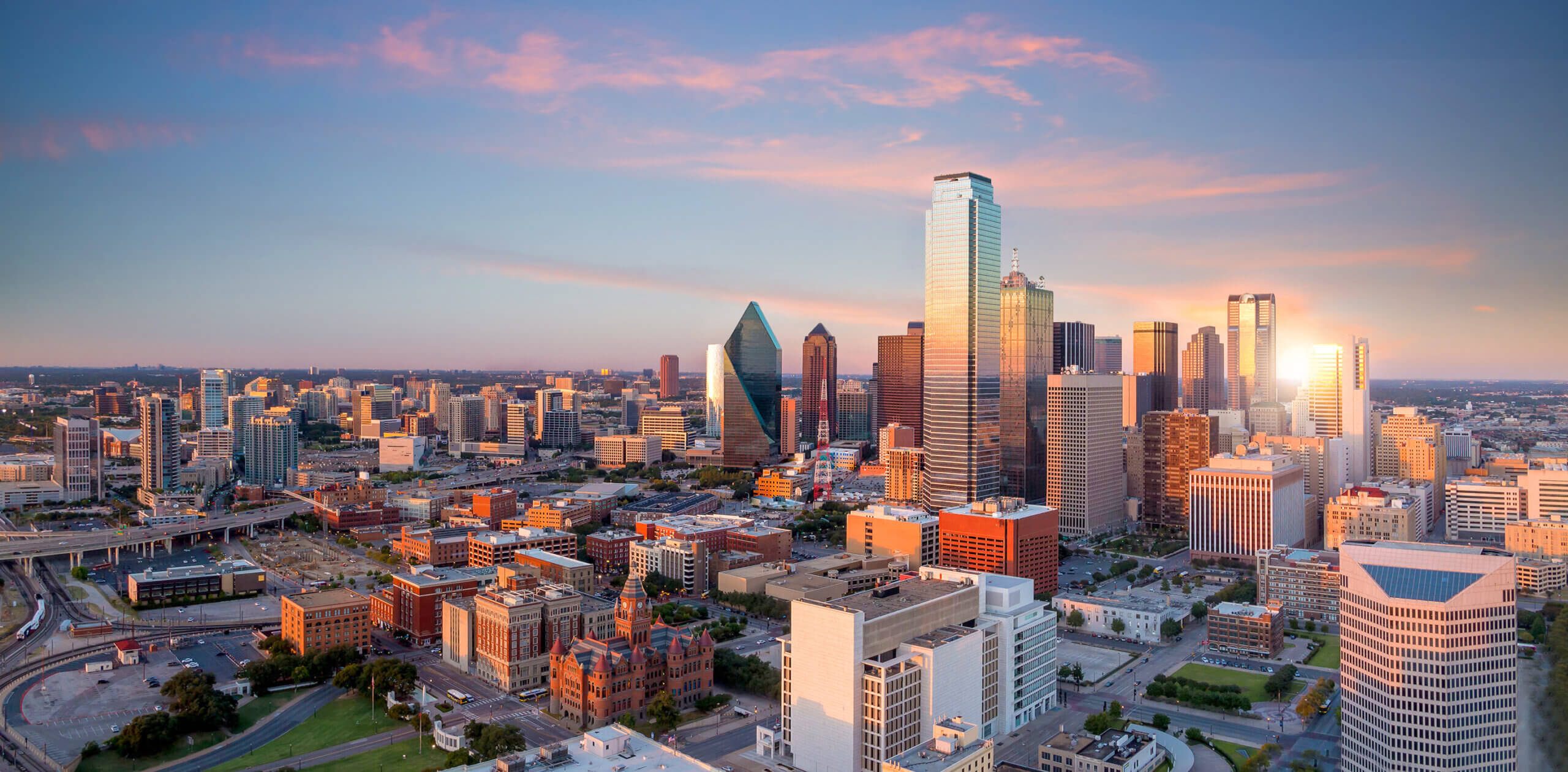 Dallas, Texas cityscape with blue sky at sunset in USA