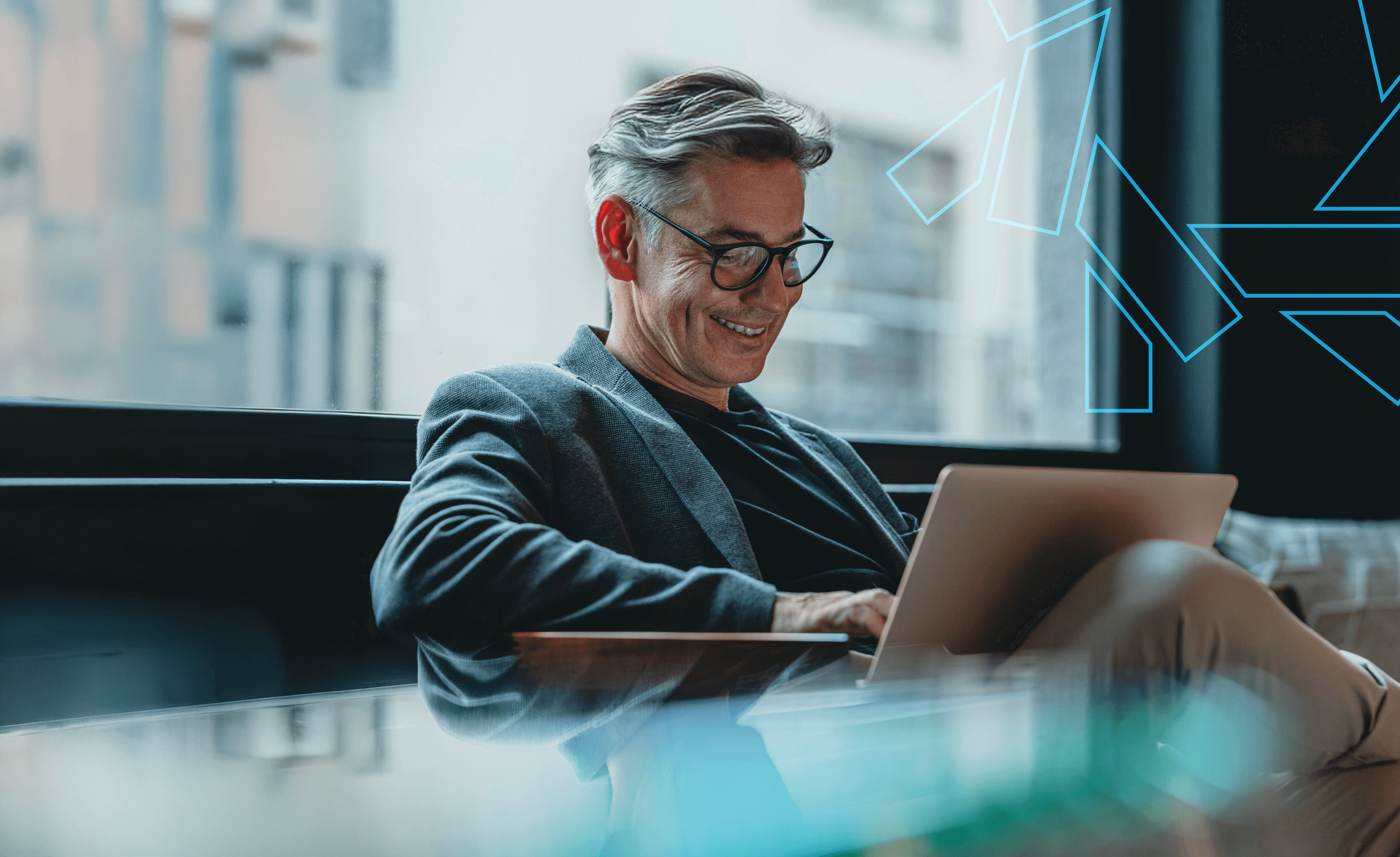 a smiling, middle-aged man wearing glasses and a blazer