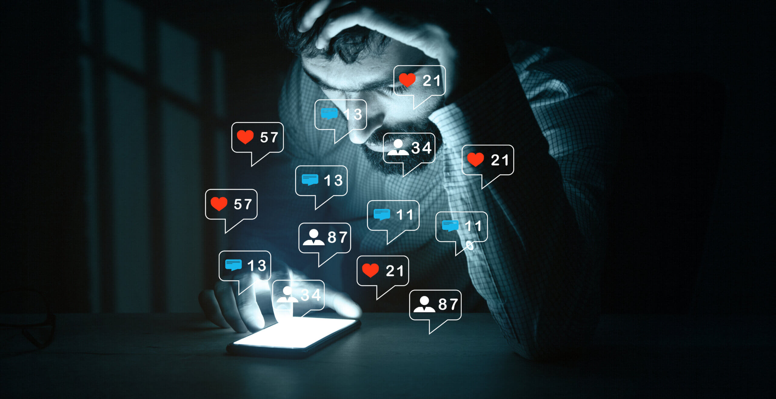 A man sits in the dark, looking stressed while staring at his smartphone, which glows brightly. Around him are floating social media notification icons showing likes, comments, and followers, symbolizing the overwhelming pressure of online engagement.