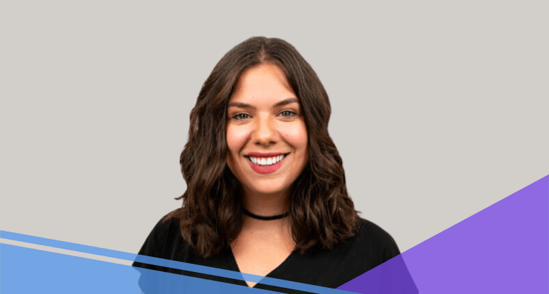 A woman with shoulder-length wavy brown hair smiles at the camera. She is wearing a black top and a black choker necklace. The background is light gray with diagonal blue and purple graphic shapes at the bottom.