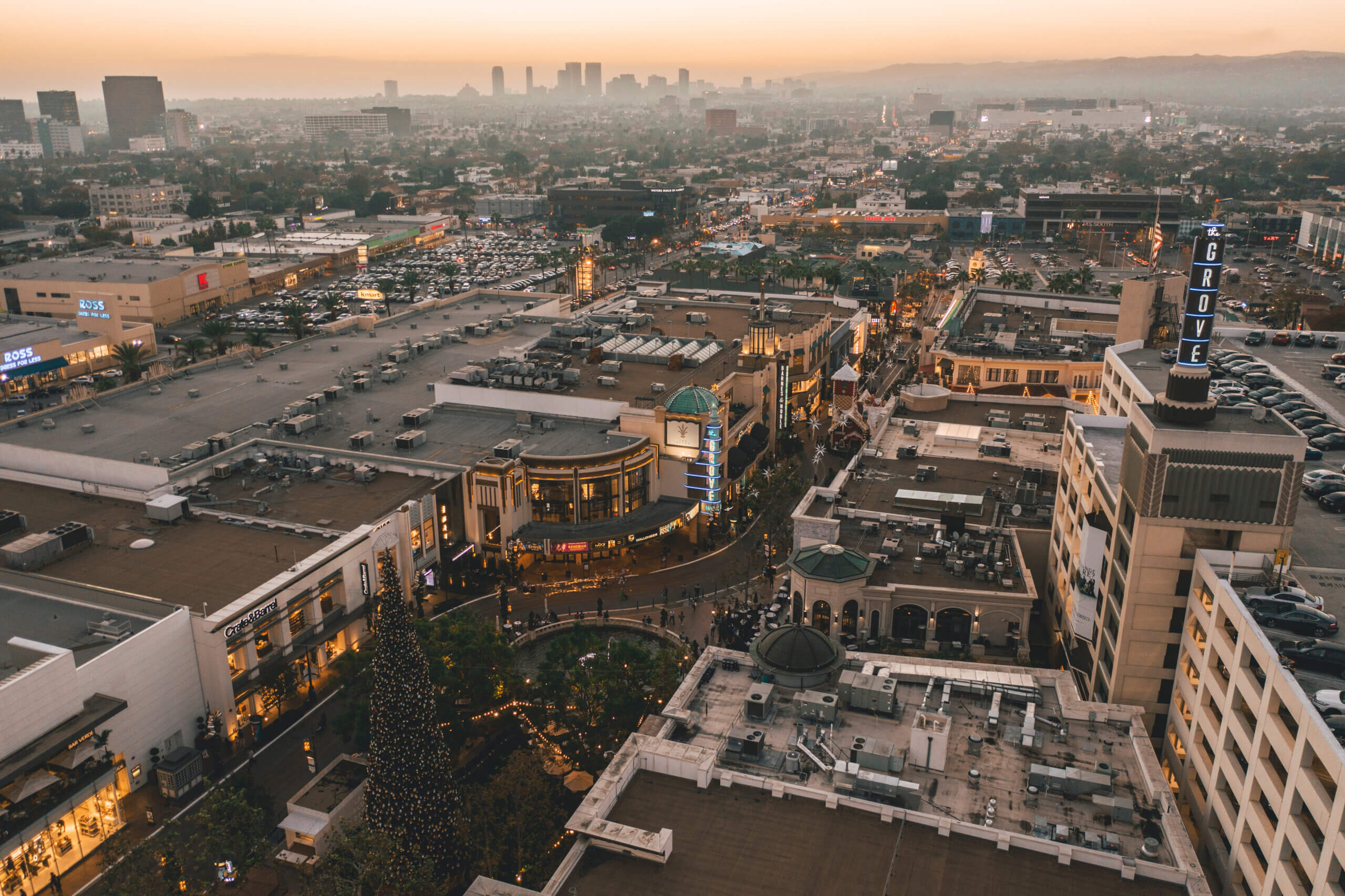 The Grove Shopping Center in Los Angeles at Sunset with Shops and Hollywood Skyline in the distance HQ